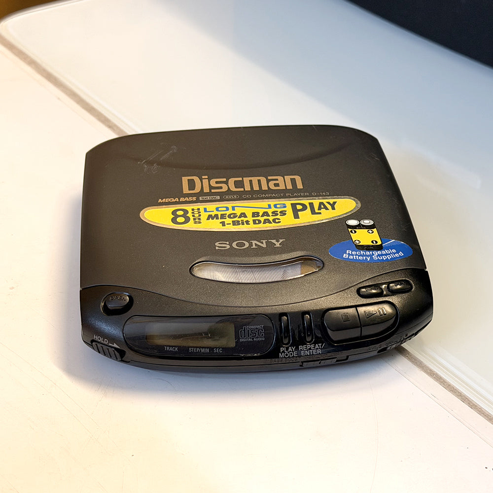 (Pre-Owned, Very Good) Sony Discman D-143 Portable CD Player (Gray) (60 Days Warranty) + 1 Music CD